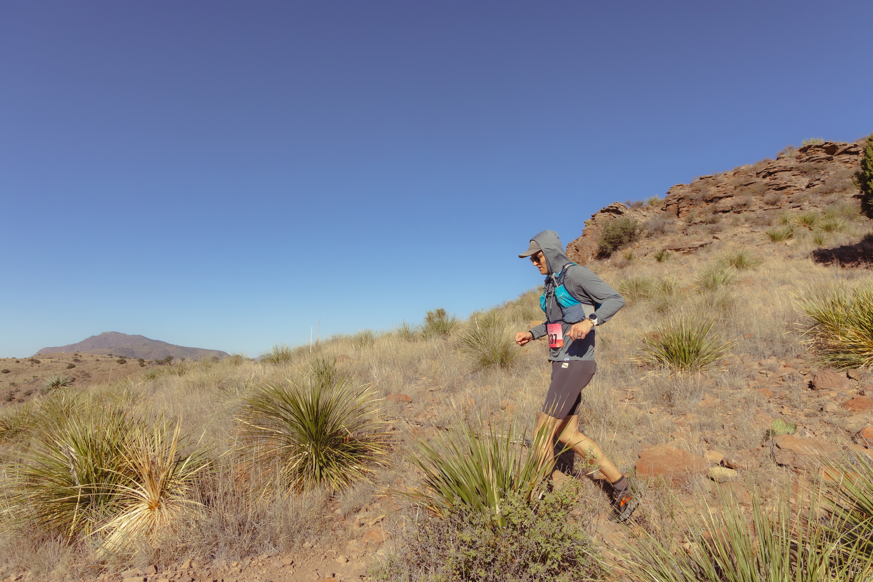 Ryan descending a sunny, rocky trail at the Sky Island 25k race